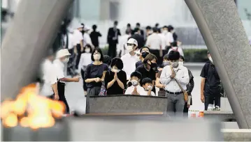  ?? Kyodo News via AP ?? Visitors pray in front of the cenotaph dedicated to the victims of the atomic bombing at the Hiroshima Peace Memorial Park in Hiroshima, western Japan on Saturday as the nation marked the 77th anniversar­y of the world’s first atomic bombing of the city.