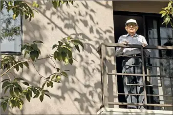  ?? Genaro Molina Los Angeles Times ?? JOE GOLDFARB stands on the balcony of his apartment. A Holocaust survivor, he turns 104 on March 17.