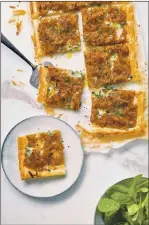  ?? PHOTO BY CHRIS TERRY ?? This savory French onion and blue cheese tart is featured in Nadiya Hussain’s new cookbook, “Nadiya Bakes,” published by Clarkson Potter.