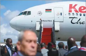  ?? MENG CHENGUANG / XINHUA ?? A Boeing 777-300ER aircraft waits at Jomo Kenyatta Internatio­nal Airport in November for the first direct flight by Kenya Airways from Nairobi to Guangzhou, the capital of Guangdong province.