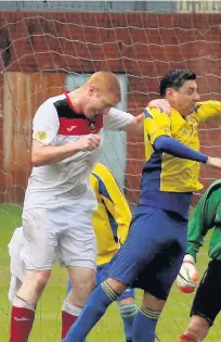  ??  ?? Llanhillet­h Athletic defender Michael Osland clears from a