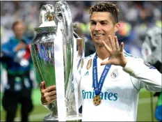  ??  ?? In this May 26, file photo Real Madrid’s Cristiano Ronaldo celebrates with the trophy after winning the Champions League Final soccer match between Real Madrid and Liverpool at the Olimpiyski­y Stadium in Kiev, Ukraine. AP PhoTo/PAVeL goLoVkIn