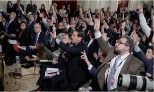  ??  ?? Reporters raise their hands during President Donald Trump news conference in the East Room of the White House in Washington.