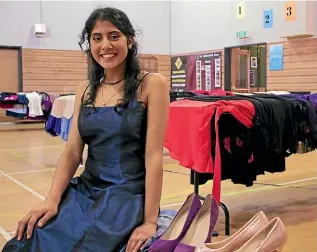  ?? ELEANOR WENMAN/ STUFF ?? St Catherine’s College student Sapna Vyas shows off a potential ball outfit, chosen from the dozens of ballgowns donated to the school.