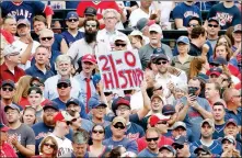  ?? ASSOCIATED PRESS ?? CLEVELAND INDIANS FANS CELEBRATE their team’s 5-3 victory over the Detroit Tigers in Cleveland on Wednesday. The Indians set the American League record with 21 consecutiv­e wins.