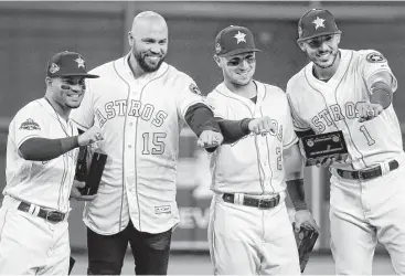  ?? Karen Warren / Houston Chronicle ?? Left to right, Jose Altuve, Carlos Beltran, Alex Bregman and Carlos Correa show their new World Series rings before the start of Tuesday’s game at Minute Maid Park.