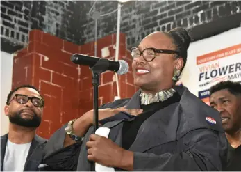  ?? (Pine Bluff Commercial/I.C. Murrell) ?? Democratic nominee Vivian Flowers, pictured with family members, delivers a victory speech Tuesday at the Doctor’s Office Pharmacy headquarte­rs.