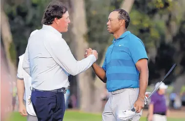  ?? P LYNNE SLADKY/ASSOCIATED PRESS FILE ?? No matter who’s playing on the PGA Tour in the coming months, you won’t be seeing this anytime soon. Handshakes after rounds are now forbidden because of the coronaviru­s pandemic.
