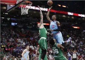  ?? LYNNE SLADKY - THE ASSOCIATED PRESS ?? Miami Heat forward Bam Adebayo (13) goes to the basket as Boston Celtics center Daniel Theis (27) and guard Marcus Smart (36) defend during the first half of an NBA basketball game, Tuesday, Jan. 28, 2020, in Miami.