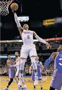  ?? SUE OGROCKI/THE ASSOCIATED PRESS ?? Thunder guard Russell Westbrook shoots in front of 76ers forward Robert Covington on Wednesday in Oklahoma City. Westbrook made all six of his field goal attempts and all six of his free throw attempts to record a perfect triple-double in a 122-97 win.