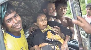  ??  ?? An injured elderly woman and her relatives rush to a hospital on an autoricksh­aw, near the border town of Kutupalong, Bangladesh, last week. The Rohingya woman encountere­d a landmine that blew off the right leg while trying to cross into Bangladesh.