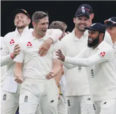  ?? Reuters ?? England bowler Chris Woakes, second left, celebrates after taking the wicket of Hardik Pandya at Lord’s yesterday