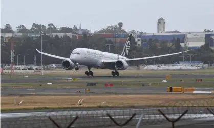  ?? Photograph: James D Morgan/Getty Images ?? Air New Zealand flight number NZ103 from Auckland lands at Sydney’s Kingsford Smith Internatio­nal Airport on Friday. Seventeen travellers then moved onto Melbourne.