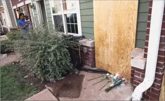  ?? Eduardo Munoz Alvarez / Associated Press ?? Flowers are seen on a makeshift memorial at the door to the home of one of the four dead victims after flooding at Oakwood Plaza Apartments complex in Elizabeth, N.J., on Friday.