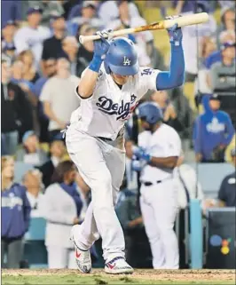  ??  ?? CODY BELLINGER is frustrated after popping out to Milwaukee shortstop Orlando Arcia with runners in scoring position and no outs in the ninth inning.
