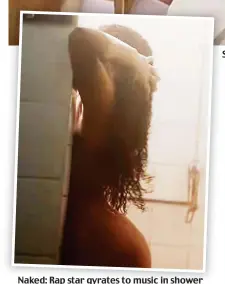  ??  ?? Naked: Rap star gyrates to music in shower Strutting her stuff: Stefflon strolls through historic school corridor in video