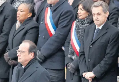  ?? AP ?? French President Francois Hollande, left, stands during a ceremony in the courtyard of the Invalides in Paris, yesterday. France mourned and honoured those killed in the Nov 13 attacks in a sombre ceremony. Behind first row are, from left: Justice...