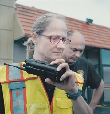  ?? Photograph­s by Netflix ?? JAN RADER, the fire chief in Huntington, W.Va., responds to a drug overdose call in “Heroin(e).” “I fear we’ve lost a couple of generation­s,” she says of the epidemic aff licting not just her city but the whole country.