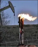  ?? AP 2021 ?? A flare burns at a well pad in 2021 near Watford City, N.D. A new study calculates that three times more of the potent, heattrappi­ng gas methane is being spewed than the government thinks.
