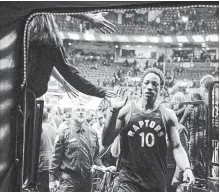  ?? CHRIS YOUNG/THE CANADIAN PRESS ?? DeMar DeRozan high fives fans in a Dec. 23, 2017 file photo. The all-star repeatedly stated his loyalty to the city of Toronto.