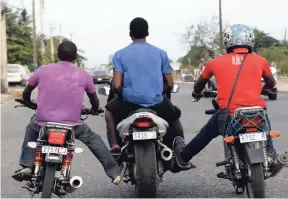 ??  ?? Some bike drivers seem to break every law on the books. In this 2015 file photo, these bikers were seen along the busy Spanish Town Road in Kingston.