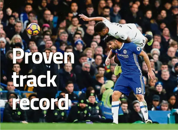  ??  ?? Taking flight: Swansea’s Kyle Naughton climbing above Chelsea’s Diego Costa during the English Premier League match at Stamford Bridge on Saturday. — AFP