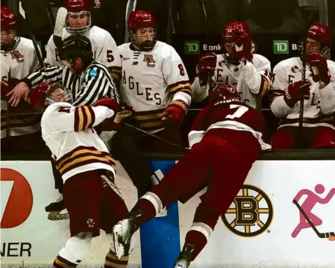  ?? BARRY CHIN/GLOBE STAFF ?? BC’s Mike Posma (left) took a major penalty for his hit on Samuli Niinisaari, but UMass couldn’t capitalize.