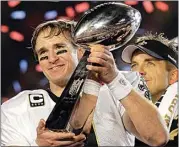  ?? JULIE JACOBSON / AP ?? In this Feb. 7, 2010, file photo, Saints quarterbac­k Drew Brees celebrates with the Vince Lombardi Trophy after the Saints’ 31-17 win over the Colts in Super Bowl XLIV in Miami.