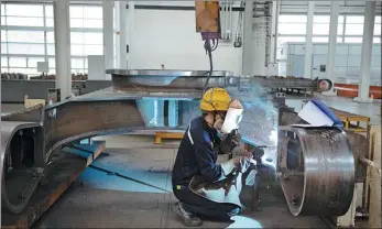  ?? JIN LIWANG / XINHUA ?? A worker performs soldering tasks at a plant of SANY Group in Lin-gang Special Area, the China (Shanghai) Pilot Free Trade Zone.