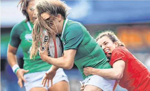  ?? GETTY ?? Ireland’s wing Beibhinn Parsons is tackled by Wales’s Jasmine Joyce during yesterday’s Six Nations clash at Cardiff Arms Park