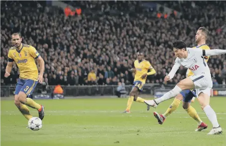  ??  ?? Son Heung-min drives home Tottenham’s opener against Juventus last night, but the Italians hit back to win through 4-3 on aggregate.