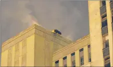  ??  ?? Firefighte­rs battle a roof fire at the old Chicago Post Office building Feb. 17. | SCOTT STEWART~SUN-TIMES