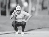  ?? KEVIN C. COX/GETTY ?? Lee Westwood lines up a putt during the second round of The Players Championsh­ip at TPC Sawgrass on Friday in Ponte Vedra Beach, Florida.