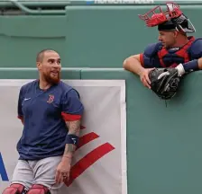  ??  ?? ‘WHERE YOU BEEN?’ Christian Vazquez (left) talks with Kevin Plawecki during summer camp on Friday.