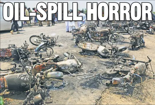  ??  ?? Charred motorbikes litter a road in Bahawalpur Sunday after a wrecked tanker exploded as hundreds flocked to collect its spilled fuel. TRAGEDY: