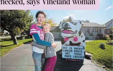  ?? JULIE JOCSAK TORSTAR ?? Julie Culp and her daughter Isabel are photograph­ed at the end of their driveway where they are trying to call attention to the importance of mammograms during breast cancer awareness month.