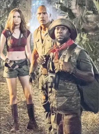  ?? Frank Masi Columbia Pictures ?? “JUMANJI: Welcome to the Jungle,” with Karen Gillan, Dwayne Johnson, center, and Kevin Hart, has earned more than $400 million in the U.S. alone since its December release. A sequel is in the works.