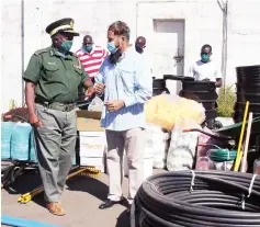  ??  ?? Zimbabwe Prison and Correction­al Service Commission­er General Paradzai Zimondi elbow shakes with Islamic Cultural Institute representa­tive Khuliq Abdullah during the donation of Covid-19 items at the Harare Central Prison yesterday. — Picture: Innocent Makawa