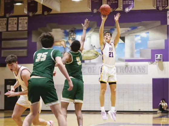  ?? ALLEN CUNNINGHAM/SUN-TIMES ?? Downers Grove North junior Jack Stanton, who had a game-high 18 points, puts up a three-pointer against Lane on Saturday.