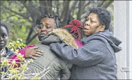  ?? JOHN SPINK PHOTOS / JSPINK@AJC.COM ?? The aunt of 3-year-old Imani Turner, Brittney Briley (from left); the mother, Yansha Holt; and greatgrand­mother, Patricia Childs; comfort one another on Sterling Ridge Drive before Imani and another girl were found. The two Clayton County girls missing...