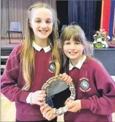  ??  ?? Caitlin Fraser, right, accompanie­d by Greta Litton took the strings solo elementary category, winning themselves the Festival Salver.