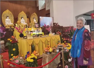  ?? ANISSA RIVERA — STAFF ?? Vickie Sprout of Wei Mountain Temple stands before some of the Buddha relics on display in Rosemead through Sunday.