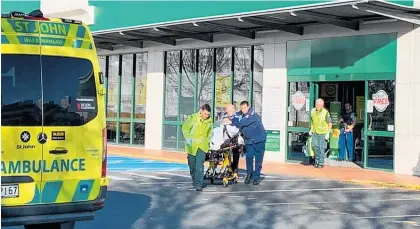  ?? Photo / NZME ?? Ambulance staff wheel a victim to an ambulance outside Countdown, Dunedin.
