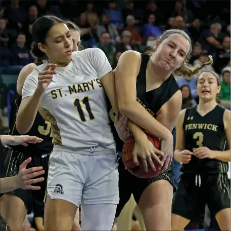  ?? STUART CAHILL — BOSTON HERALD ?? St. Mary’s Bella Owumi, left, battles Bishop Fenwick’s Kate McPhail for the ball as St Mary’s takes on Bishop Fenwick in the Div. 3 girls basketball state championsh­ip at the Tsongas Center in Lowell.