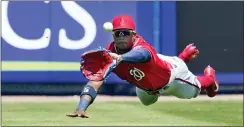  ?? SUE OGROCKI — THE ASSOCIATED PRESS ?? Washington center fielder Victor Robles dives for and catches a ball hit by the Mets’ Jeff McNeil for an out in the first inning of a spring training game on Saturday in Port St. Lucie, Fla.