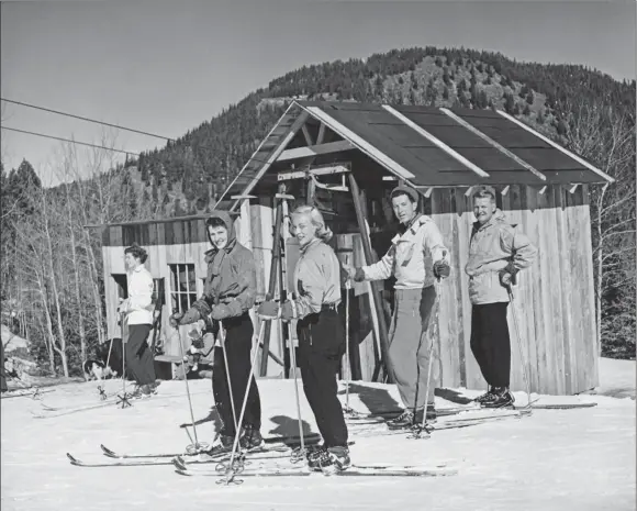  ?? COURTESY VERNE SACKETT/State Archives of New Mexico ?? A group of skiers wait to ride on the platter pull lift at Agua Piedra, a small ski area two miles west of today’s Sipapu Ski Area near Tres Ritos. In 1937, skiers from Northern New Mexico and Amarillo, Texas, banded together to form the Agua Piedra Ski Club and clear a slope just west of Tres Ritos, where Paul Bolander was building a lodge and cabins.