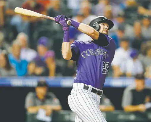  ?? David Zalubowski, The Associated Press ?? Rockies right fielder David Dahl follows the flight of his grand slam off Arizona Diamondbac­ks relief pitcher Matt Andriese during the seventh inning Monday at Coors Field. Dahl’s 10th home run of the season, and first slam of his career, gave Colorado a 102 lead.