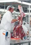  ??  ?? A meat worker works with a sheep carcass at SFF’s Finegand plant, Balclutha. Over-capacity in processing plants would be addressed by a proposed co-operative.