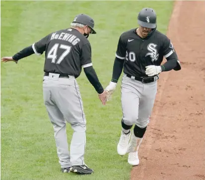  ?? AP ?? Danny Mendick gets a hand from third-base coach Joe McEwing after his two-run home run in the Sox’ eight-run first inning Saturday.