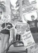  ?? JOE CAVARETTA/ SOUTH FLORIDA SUN SENTINEL ?? Anti-mask protesters make their feelings known outside of the Broward County School Board meeting Oct. 5, in Fort Lauderdale.